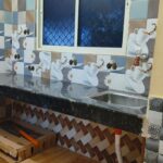 Tiled bathroom with western-style toilet and hand spray